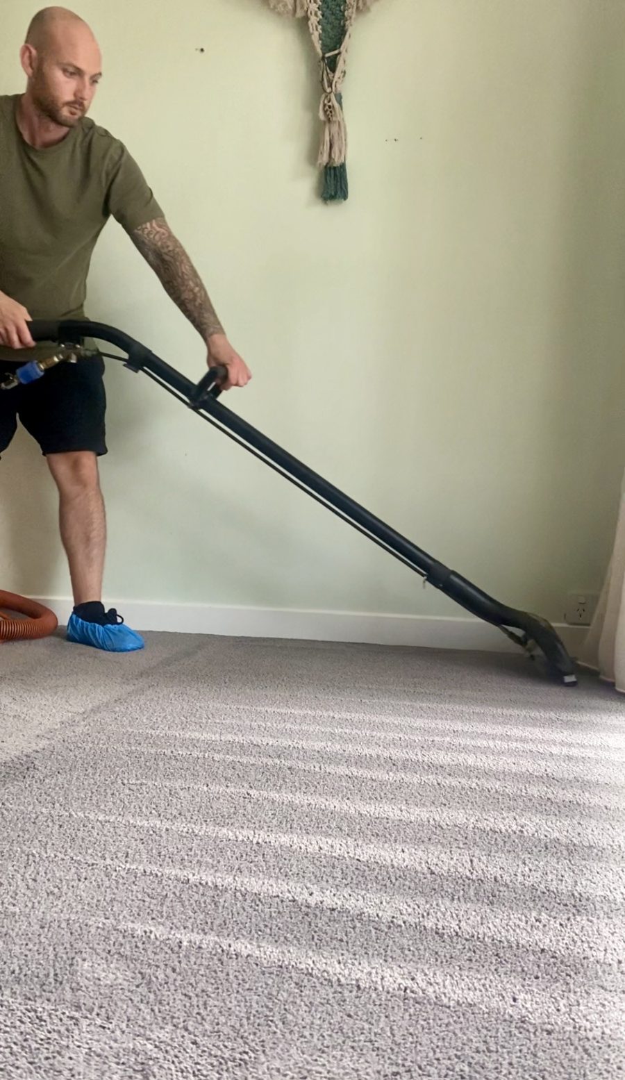 James from Natural Breeze cleaning carpet with the truck-mounted extraction wand